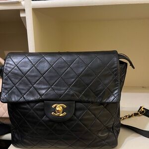 CHANEL Black Quilted Backpack with Gold Logo